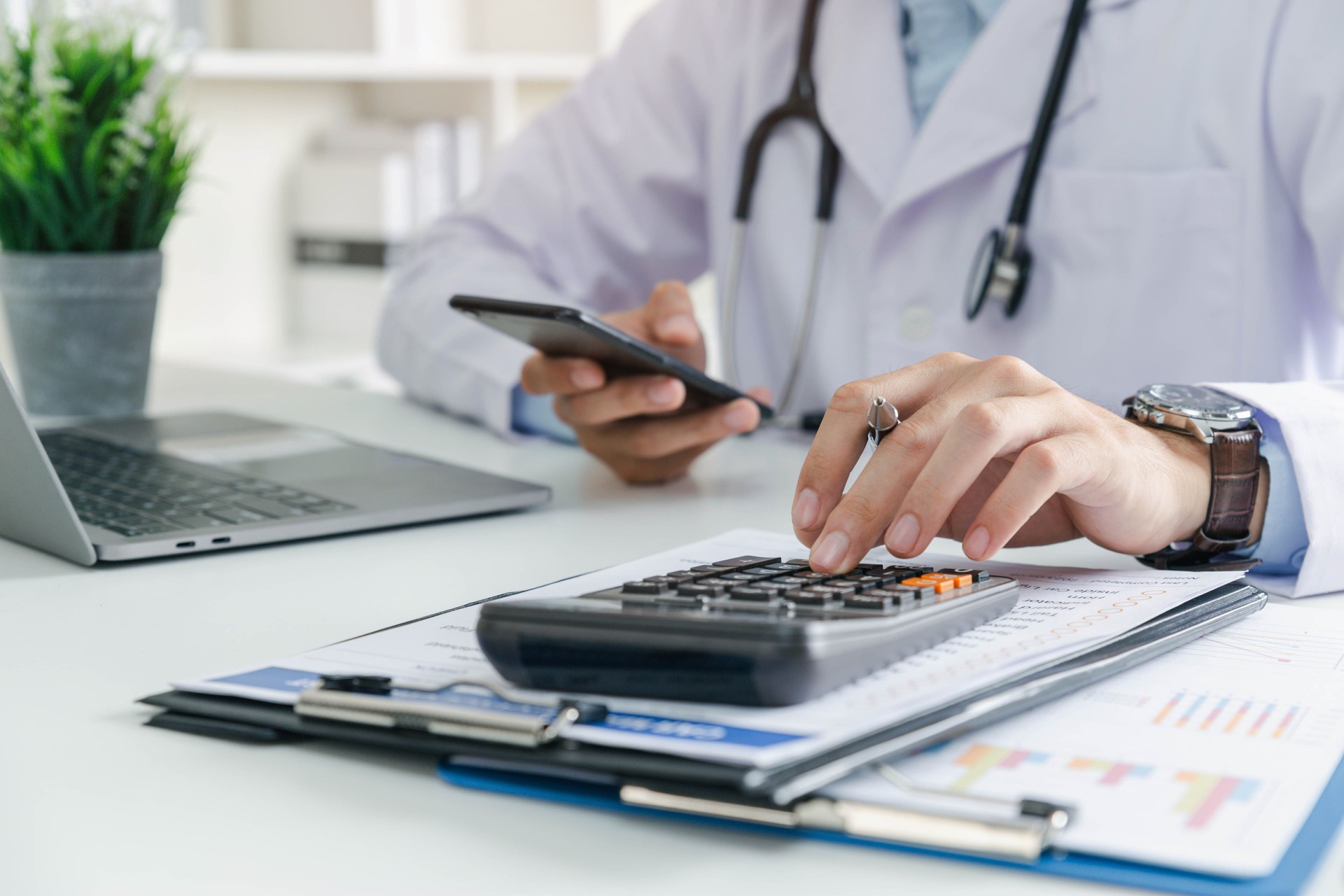 Doctor physician calculate medical healthcare fee costs and revenue
